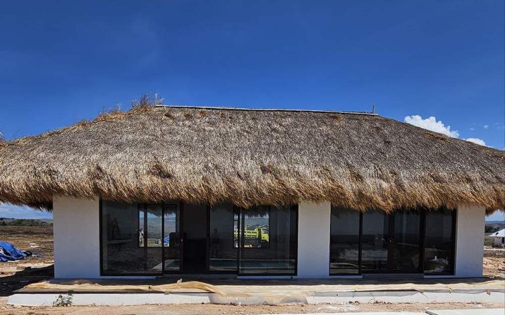 Villa exterior with thatched roof on the estate