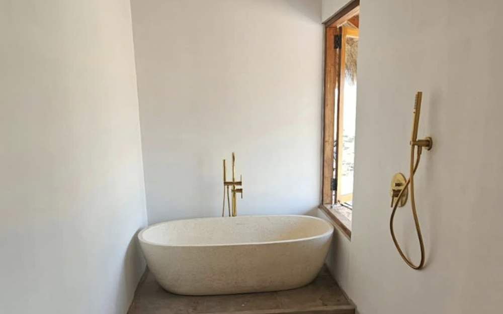 Bathroom with a stone bathtub in a finished villa